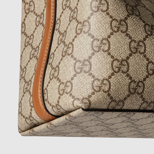 Gucci | GG Emblem small bucket bag | beige and dar...