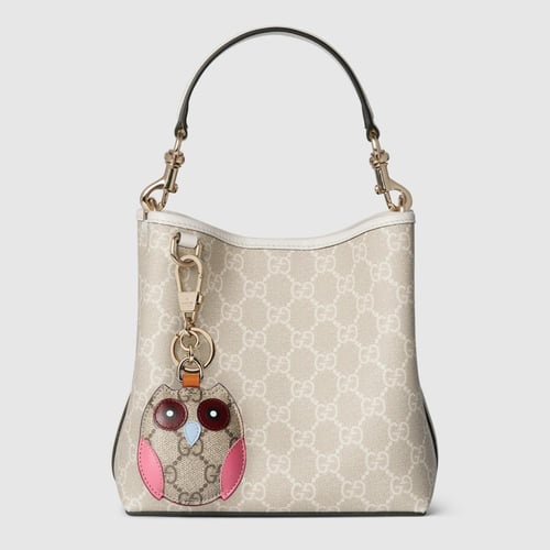 Gucci | GG Emblem small bucket bag | beige and whi...