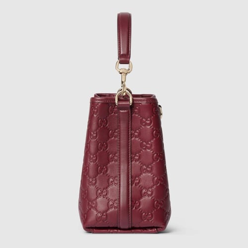 Gucci | GG Emblem small bucket bag | Rosso Ancora...