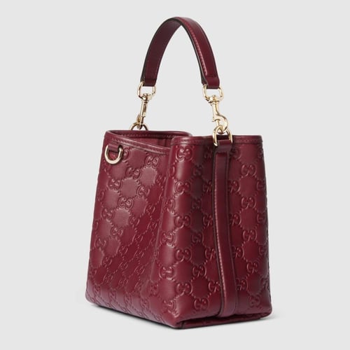 Gucci | GG Emblem small bucket bag | Rosso Ancora...