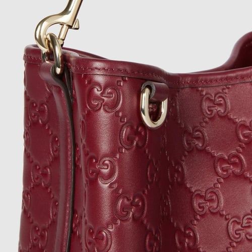 Gucci | GG Emblem small bucket bag | Rosso Ancora...