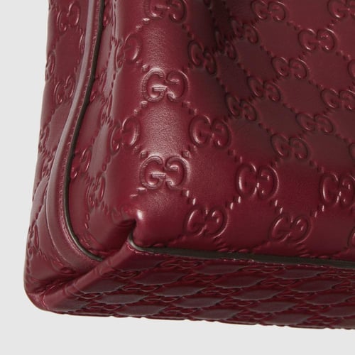 Gucci | GG Emblem small bucket bag | Rosso Ancora...