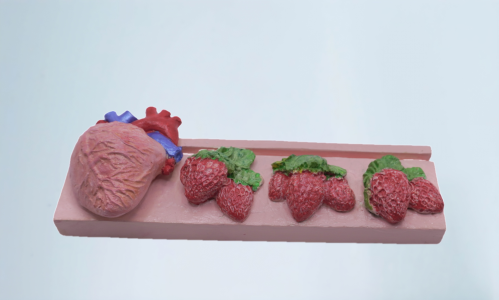The heart with strawberries on a rectangular base for holding the card