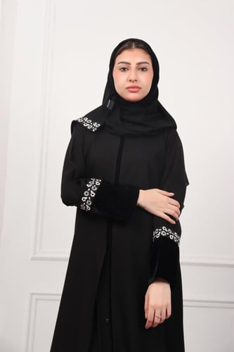 عباية زاهية بتطريز أبيض على أسفل العباية واليد