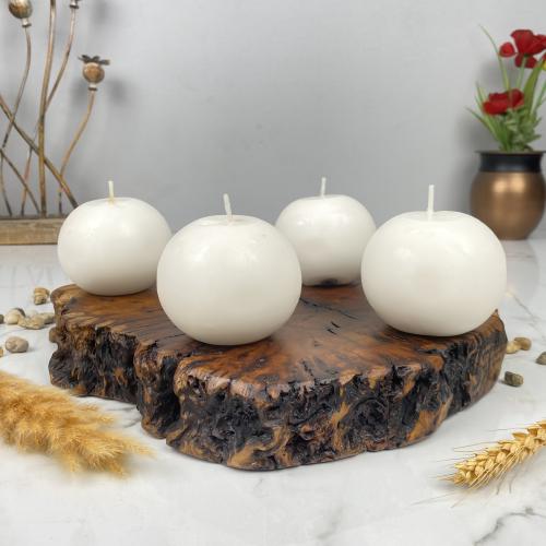 A round candle in the middle of 4 beads