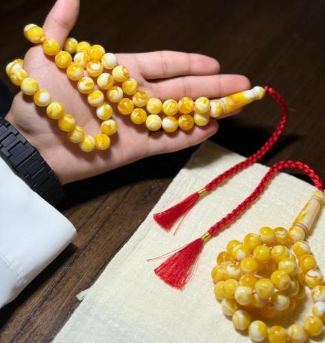 A prayer bead with a clasp chain
