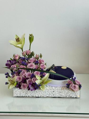 A gift combining soft flower arrangement and a lux...
