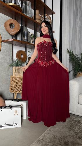 A royal maroon evening dress with luxurious embroidered details and an elegant shawl