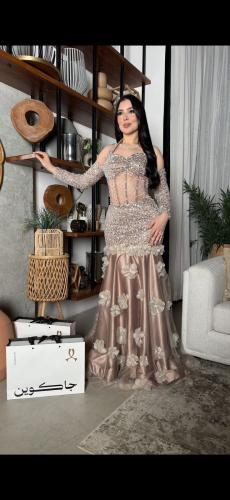 Luxury evening dress with feminine corset details and elegant shiny embroidery, decorated with prominent roses that add a touch of...
