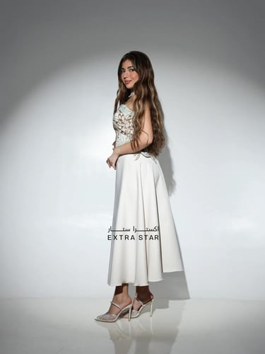 طقم نسائي بتنورة سادة وبلوزة موردة بدون أكمام