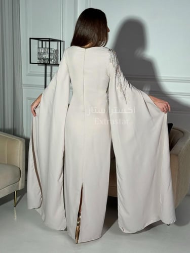 فستان سهرة بيج مطرز وبأكمام كيب منسدله