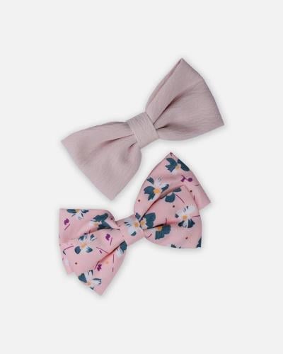 مشبكين للشعر بشكل فيونكة بلون وردي وأبيض