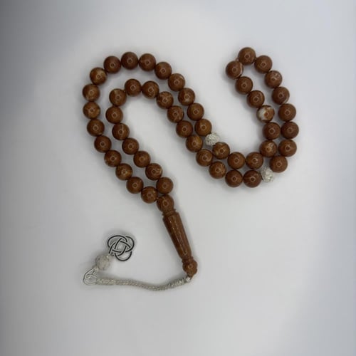 سبحه من البكلايت باللون البني بتعريقه بيضاء بتفاسي...