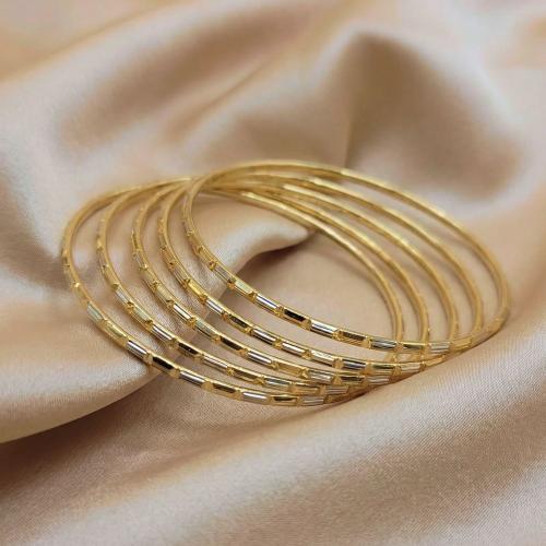 A gold and silver nail polish with a smooth, fine...