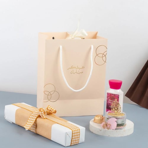 أكياس فاخرة للعيد لون بيج بدوائر ذهبية وختم "عيدكم...