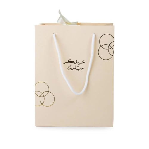 أكياس فاخرة للعيد لون بيج بدوائر ذهبية وختم "عيدكم...