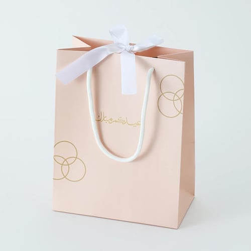 أكياس فاخرة للعيد لون بيج بدوائر ذهبية وختم "عيدكم...
