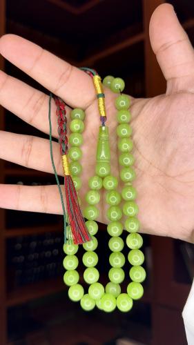 Two apple-shaped pendants with corkscrew, bead siz...