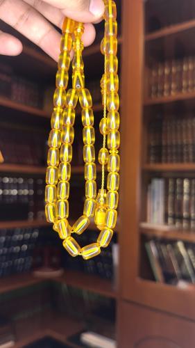 Two yellow invoices with tamlikah, number of beads...