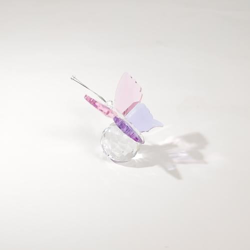 A fine crystal in the shape of a pink butterfly