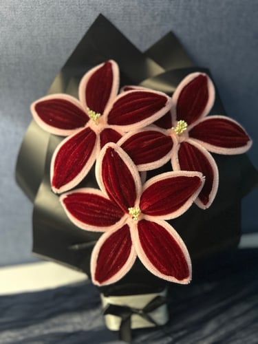 A bouquet of lilies in burgundy color