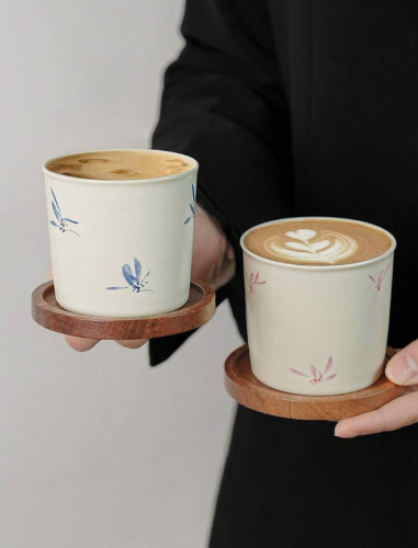 A pair of coffee cups and a plate