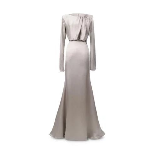 Greige silk crepe gown featuring a softly draped neckline, long sleeves, and a sculptural floral neck tie, finished with a fluid c...