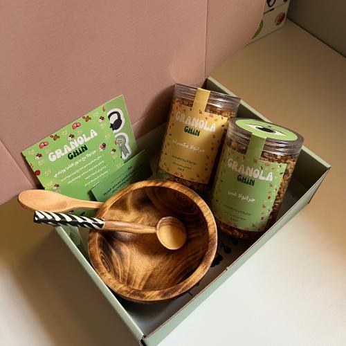 Box of granola and a distinguished wooden plate