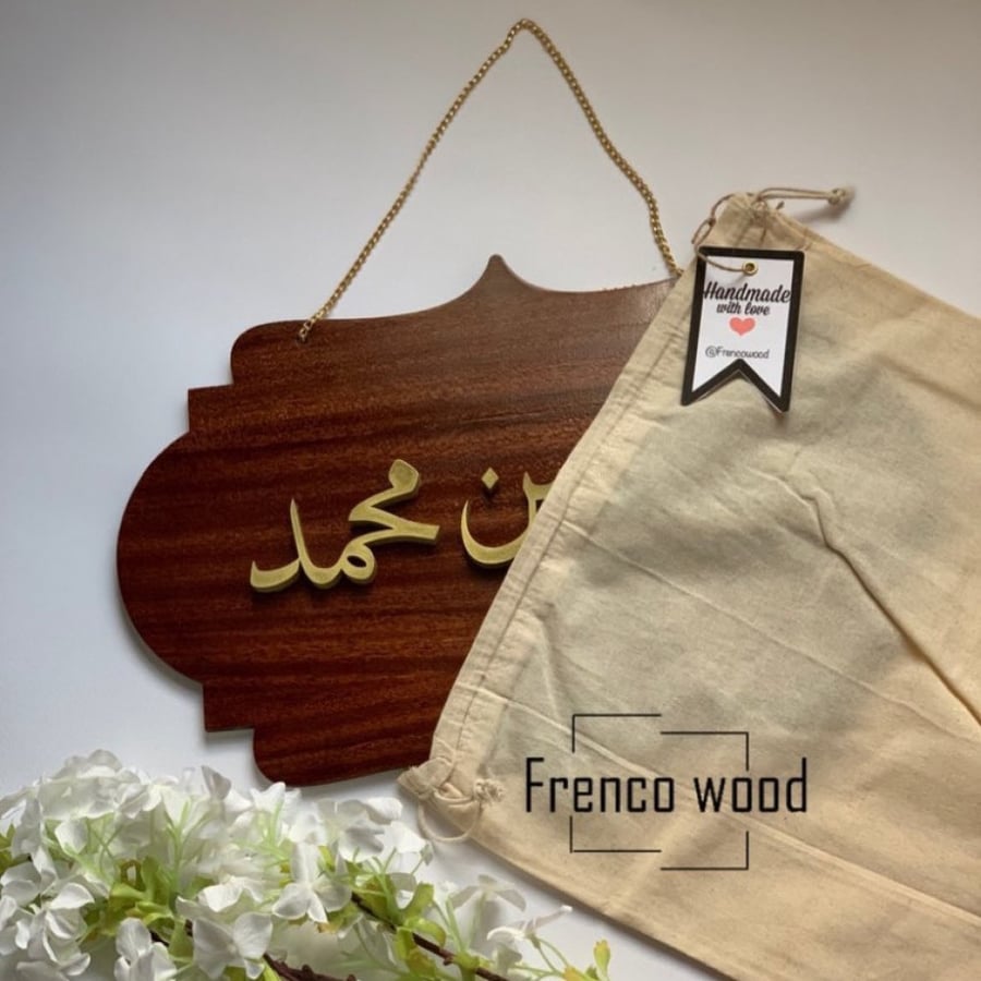 A reception pendant for a newborn with raised gold letters