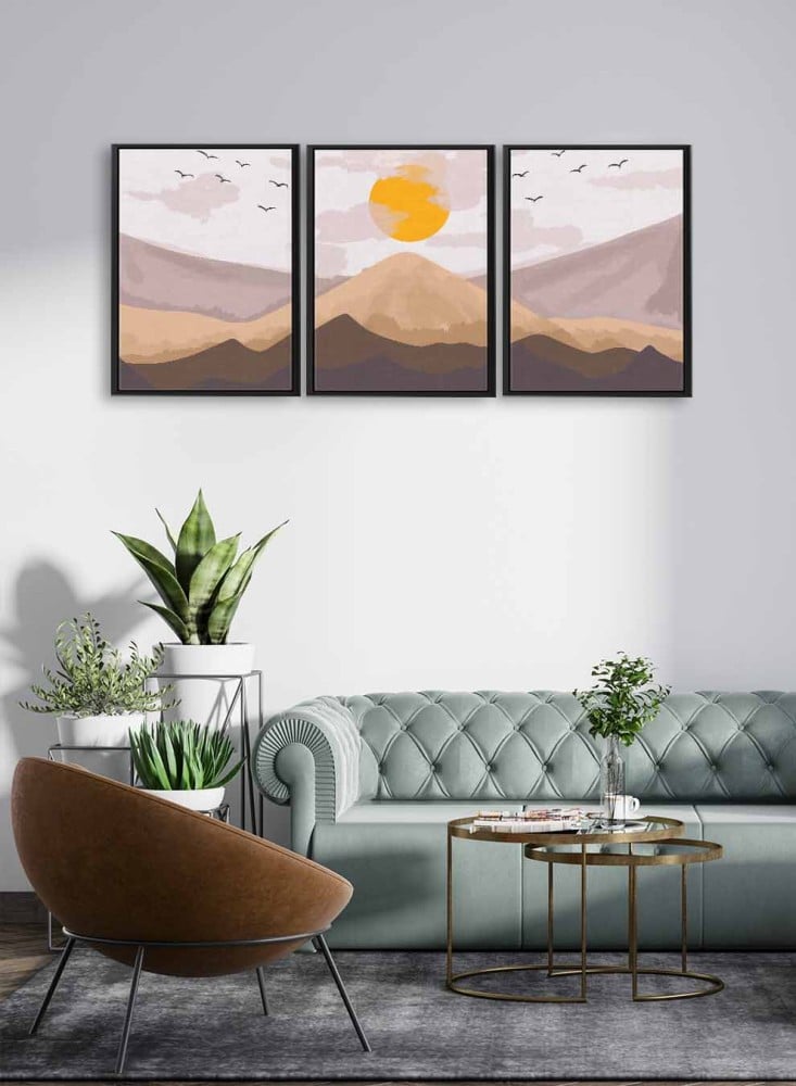 A set of 3 canvas panels on a wooden frame with an abstract art design of sunrise over the mountain