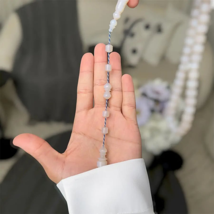 A prayer bead with a silver clasp - Mine