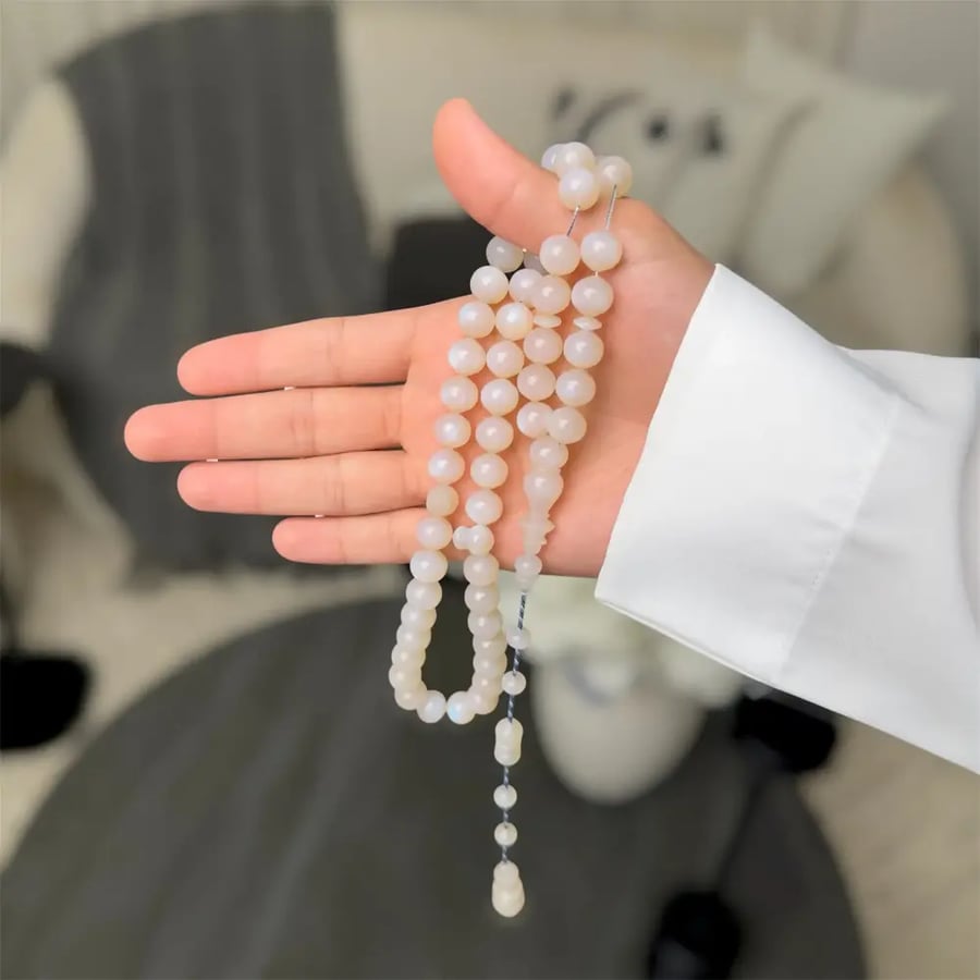 A prayer bead with a silver clasp - Mine