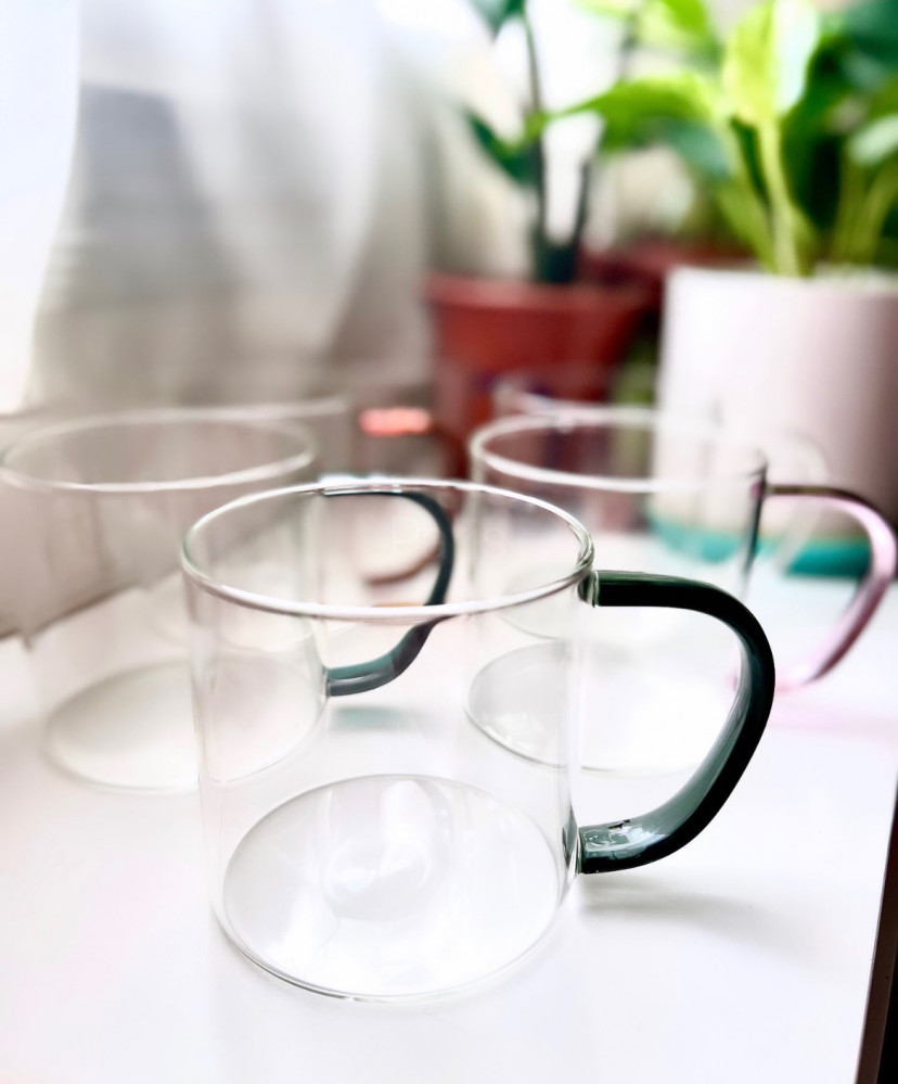 A transparent cup with a colored handle
