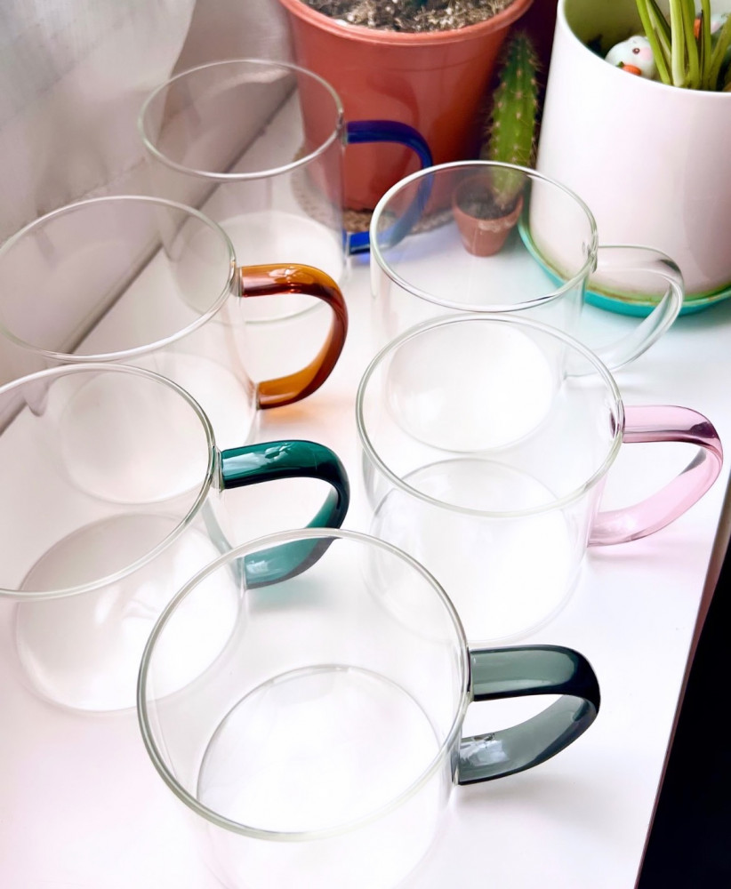 A transparent cup with a colored handle