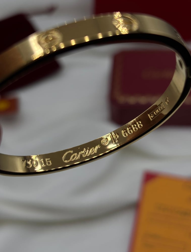 A package of two gold bracelets