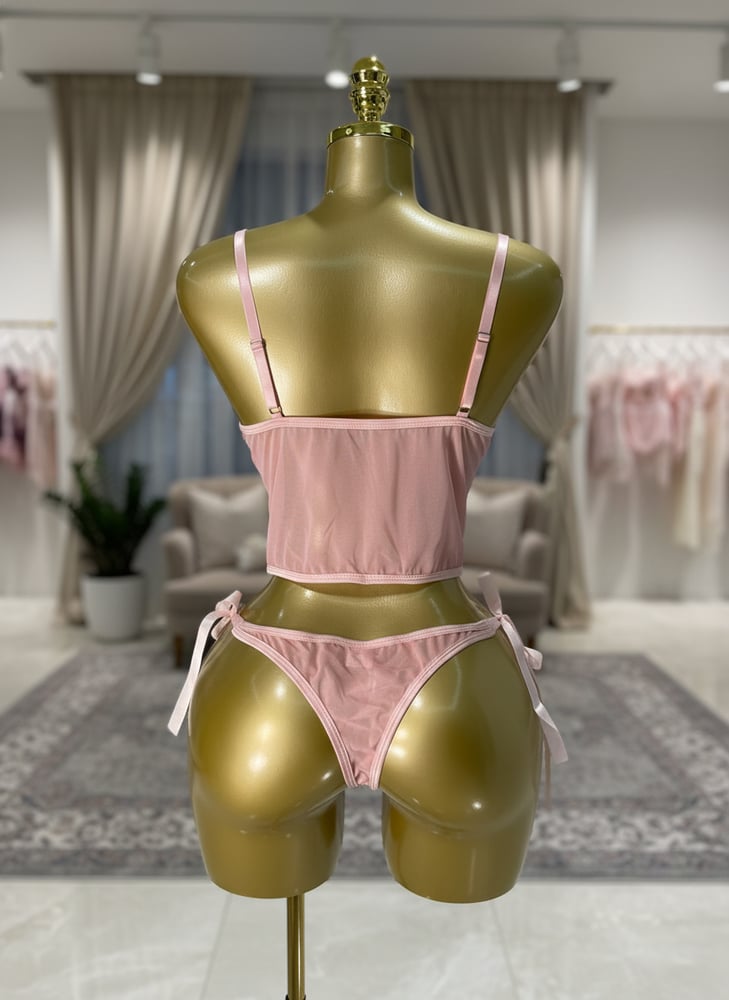 Elegant lingerie set in pink color decorated with flowers consisting of a corset and underwear with side ties
