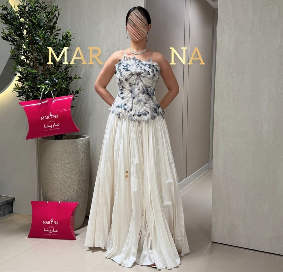 Wadiah's dress (off-white dress, velvet bodice decorated with sequins, police bag)