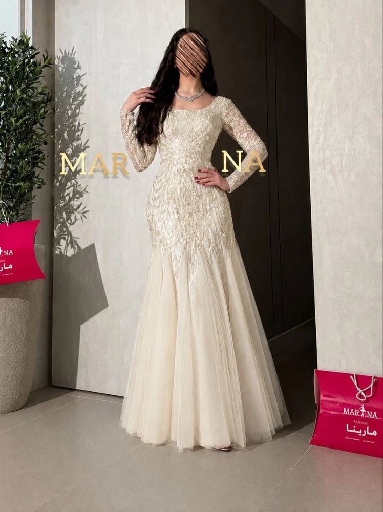 Afaf's dress (a white dress with embroidered details, suitable for evening wear, with a Taiwanese tulle insert)
