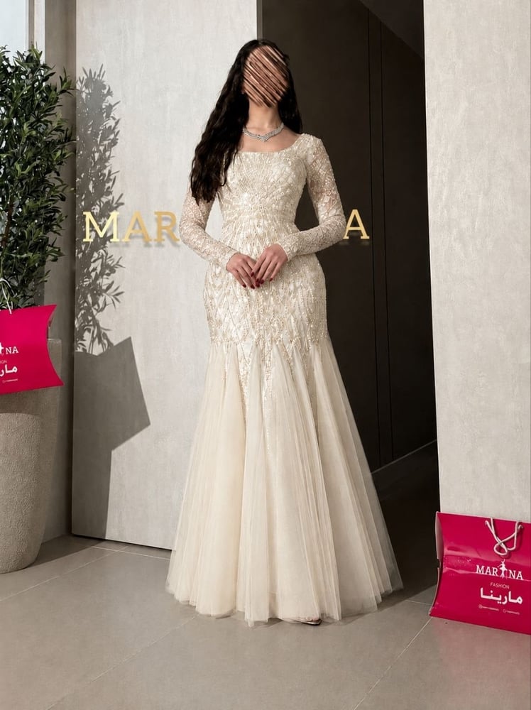 Afaf's dress (a white dress with embroidered details, suitable for evening wear, with a Taiwanese tulle insert)