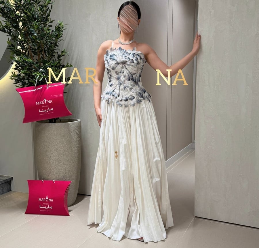 Wadiah's dress (off-white dress, velvet bodice decorated with sequins, police bag)