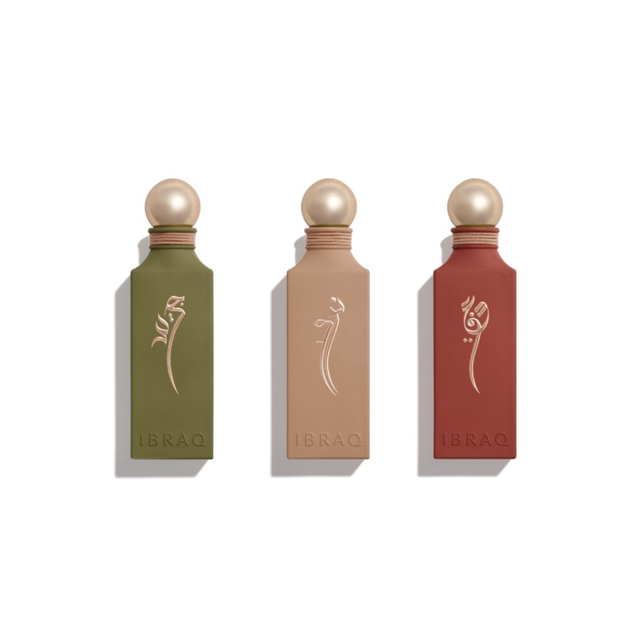 ثلاث زجاجات عطر IBRAQ بألوان ترابية وشعارات ذهبية