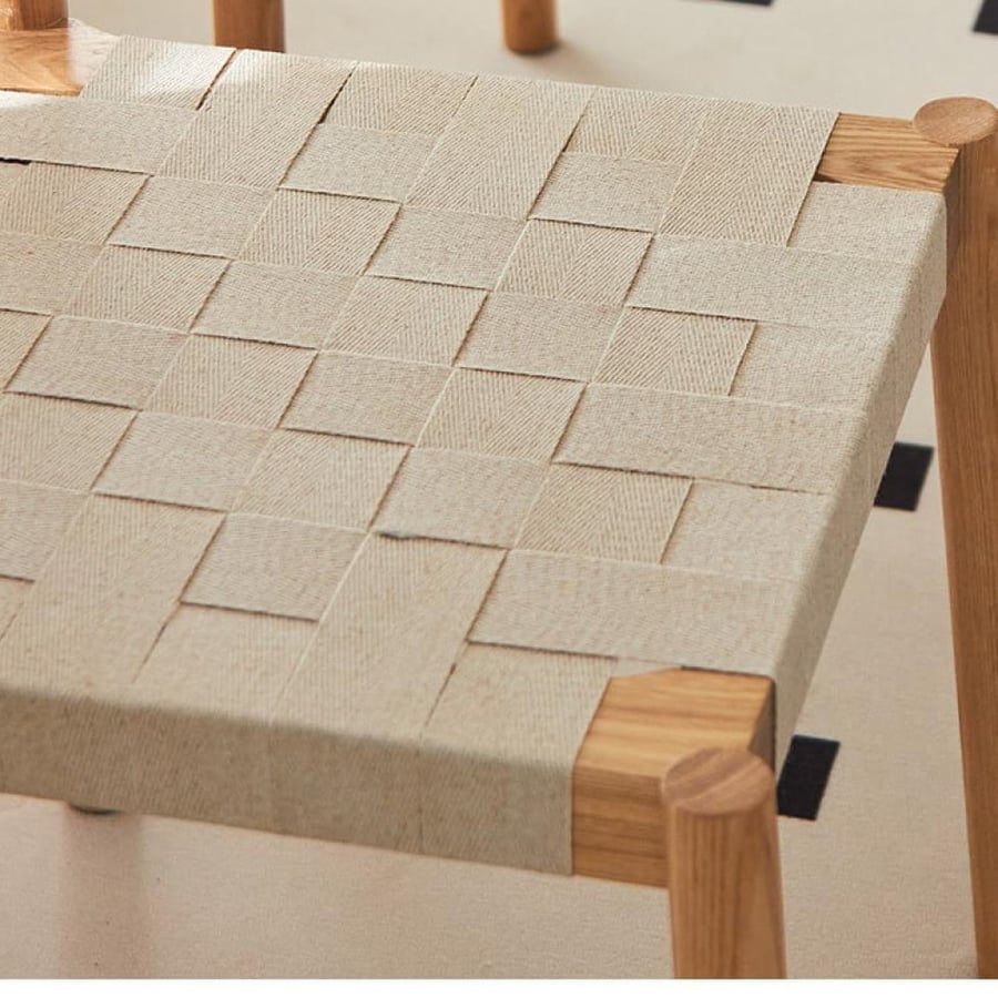 A solid wooden dining chair woven with ropes