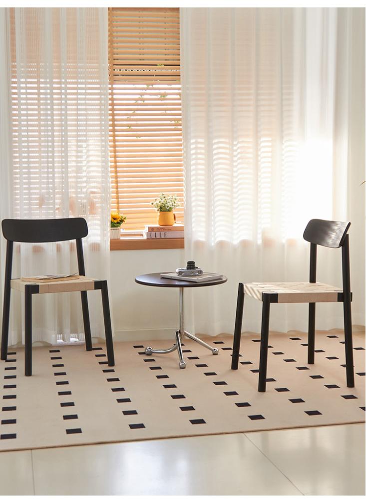 A solid wooden dining chair woven with ropes