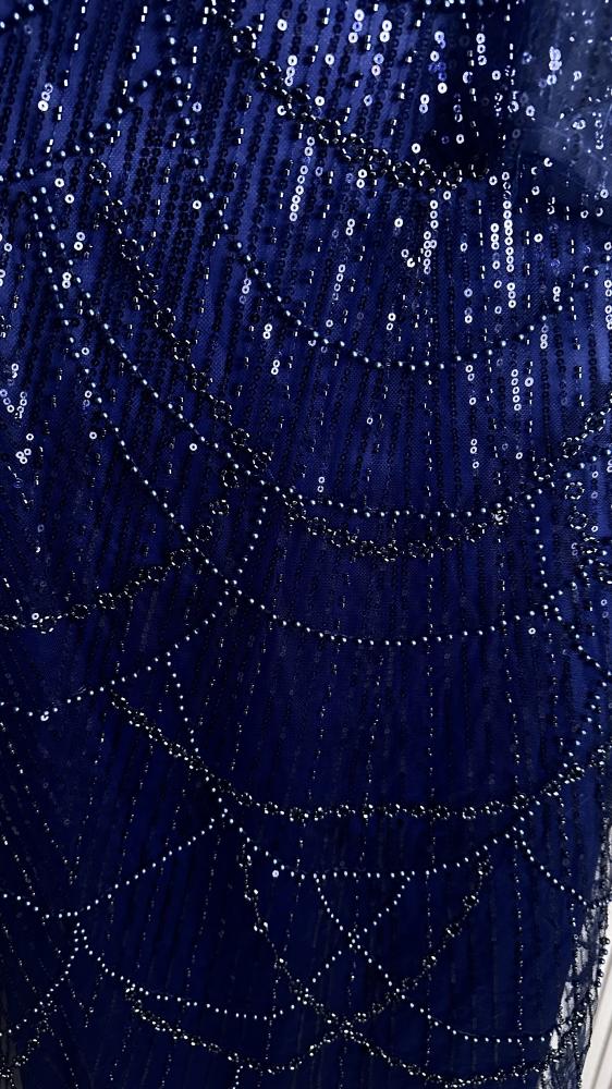 Rawan. A luxurious navy blue dress that combines elegance and sophistication. A feminine off-shoulder design with shiny embroidery that highlights the beauty of the figure with enchanting fluidity... Your perfect choice for a royal look that captures atte
