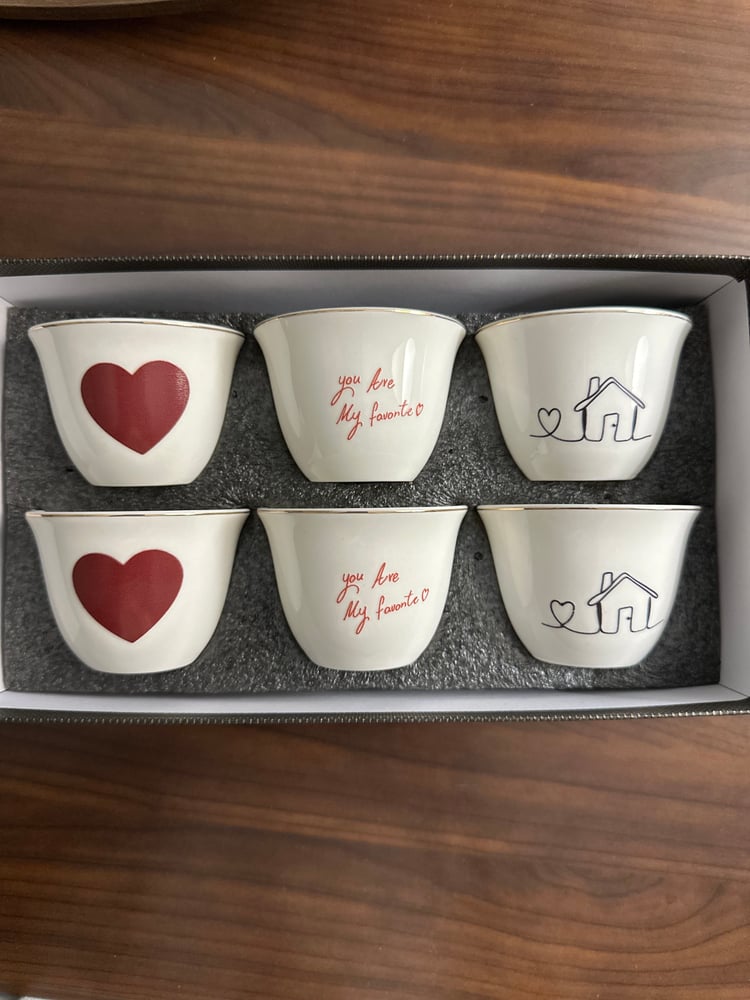 6 cups with a gentle design and an elegant white tablecloth