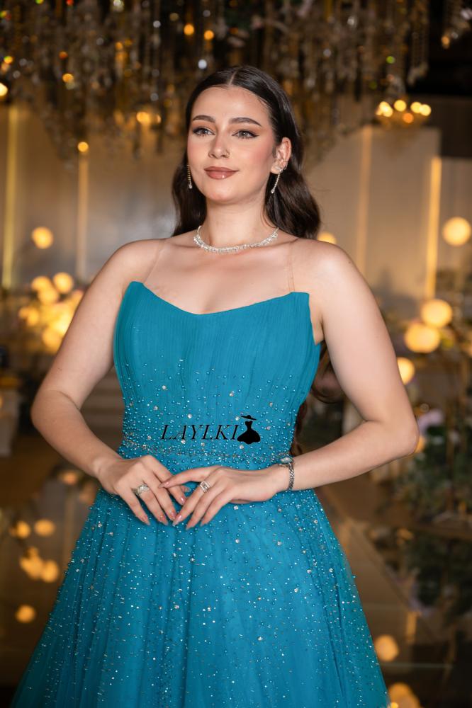 Turquoise dress with shiny embroidery and luxurious flow