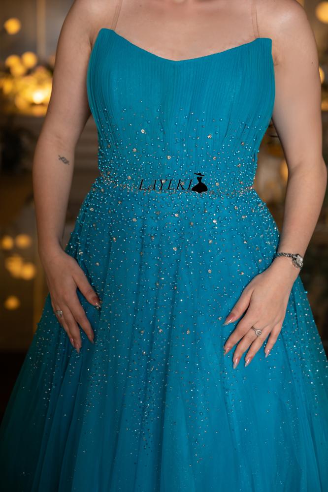 Turquoise dress with shiny embroidery and luxurious flow
