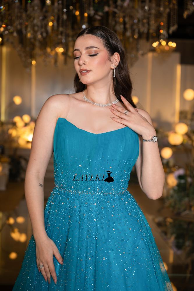 Turquoise dress with shiny embroidery and luxurious flow