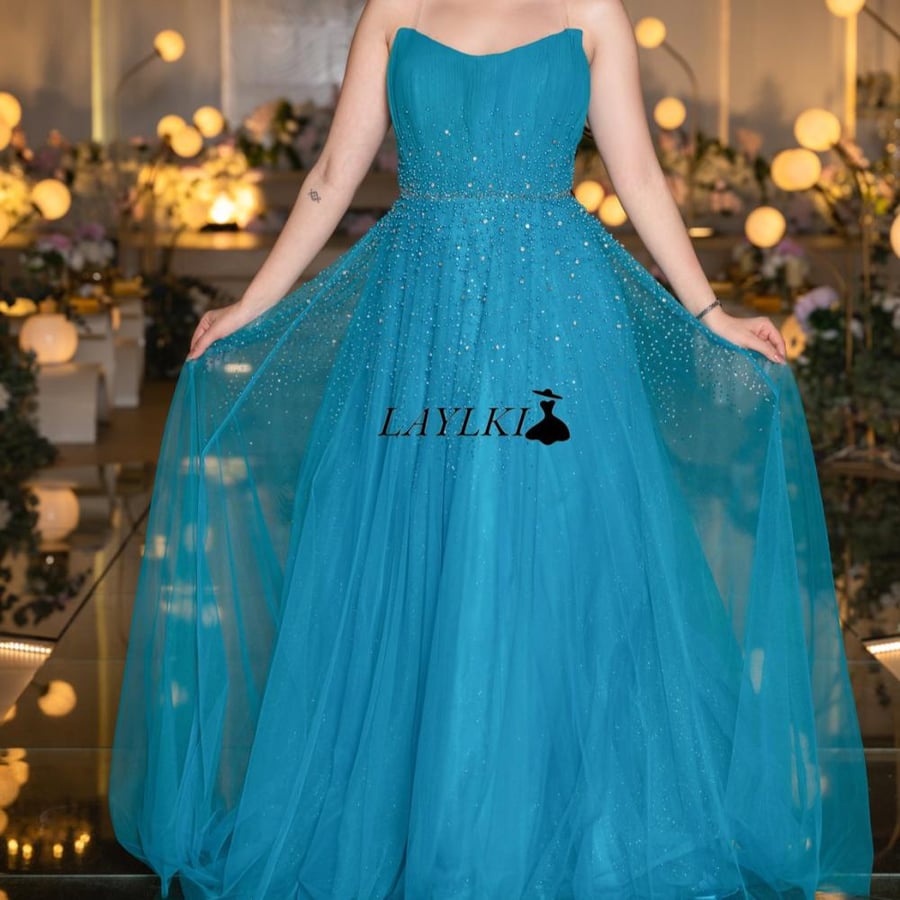 Turquoise dress with shiny embroidery and luxurious flow