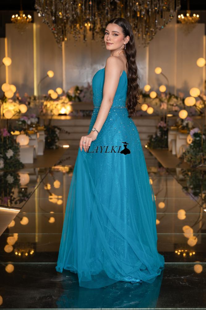 Turquoise dress with shiny embroidery and luxurious flow
